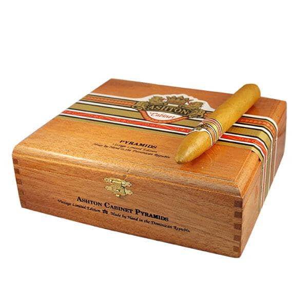 Ashton Cabinet Pyramids premium cigars in a wooden humidor, showcasing rich tobacco leaves and detailed packaging.