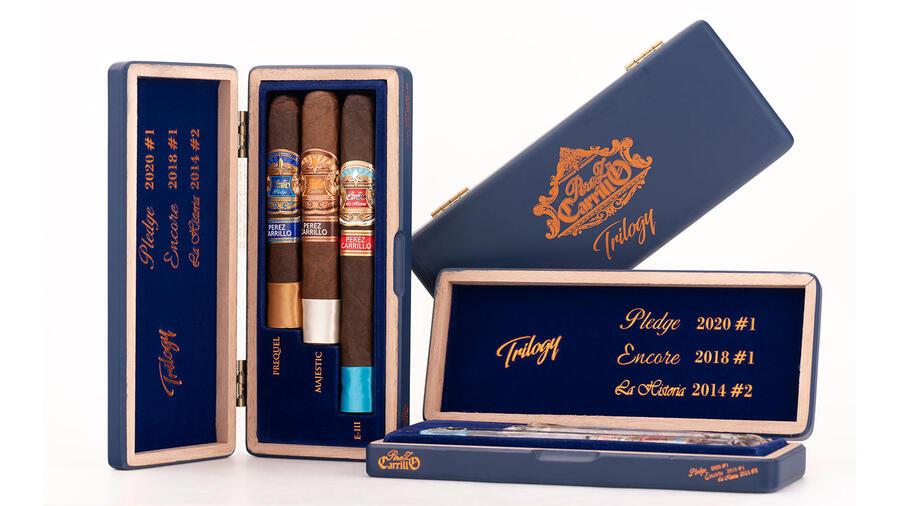 Three E.P. Carrillo Perez Carrillo Trilogy premium cigars sampler in a sleek box, showcasing individually wrapped cigars.