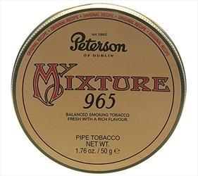 Peterson My Mixture 965 pipe tobacco in a tin, showing the colorful label and tobacco inside on a wooden surface.
