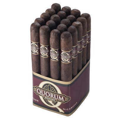 Quorum Maduro premium cigar lying on a wooden surface, showcasing its dark, oily wrapper and cylindrical shape.
